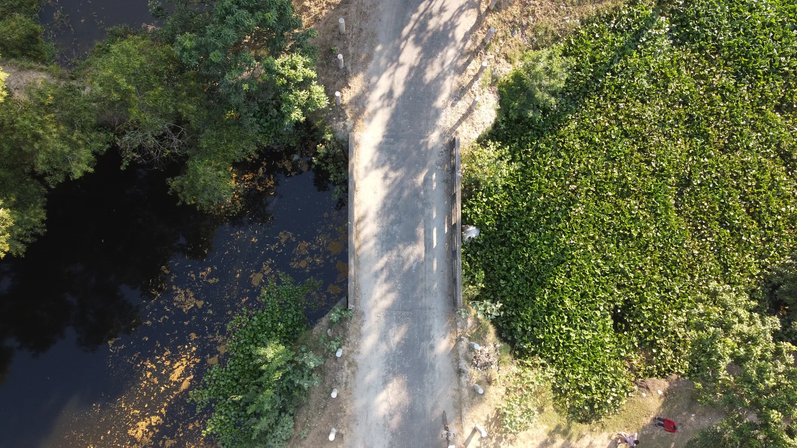 Drone view of road, bridge, and the water body it covers