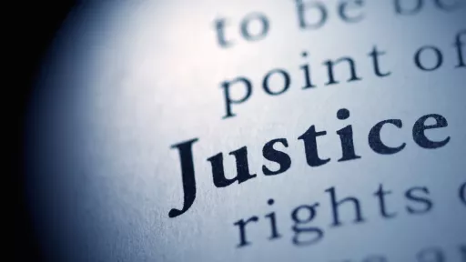 word justice in white circle