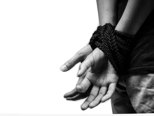 Man with hands tied